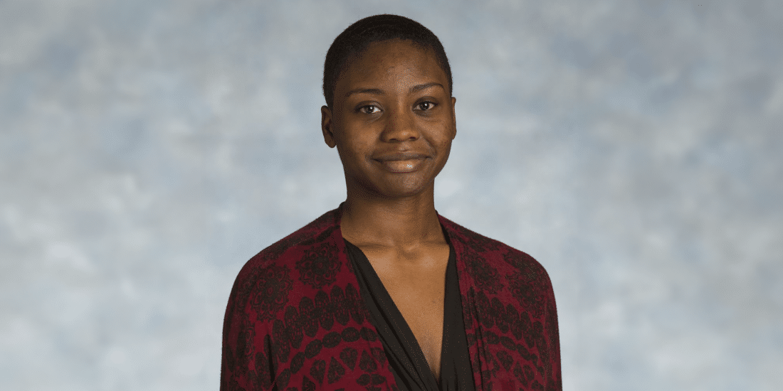 A scholarly leader, Deja Dennis '19, wearing a red and black cardigan.