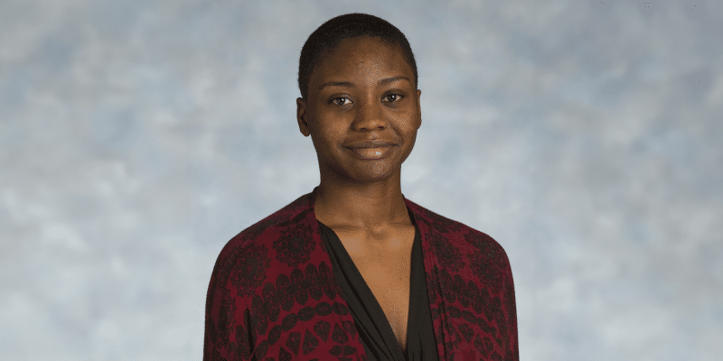 A scholarly leader, Deja Dennis '19, wearing a red and black cardigan.