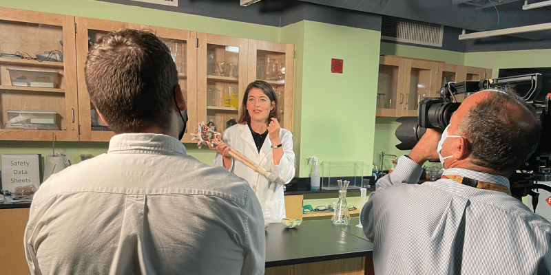 A diverse team is shooting a video in a neuroscience lab.