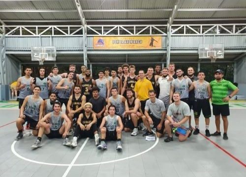 RMC mens basketball team posing for a team picture on a basketball court in Costa Rica