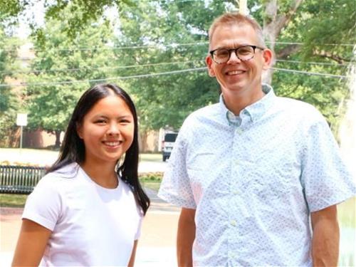 RMC student Grace Bakeman poses alongside her SURF mentor, Dr. James Doering near the fountain.