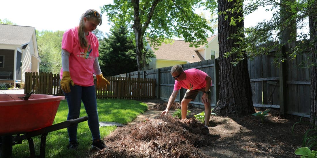 Students wearing Macon a difference day tshirts cleaning up pine needles