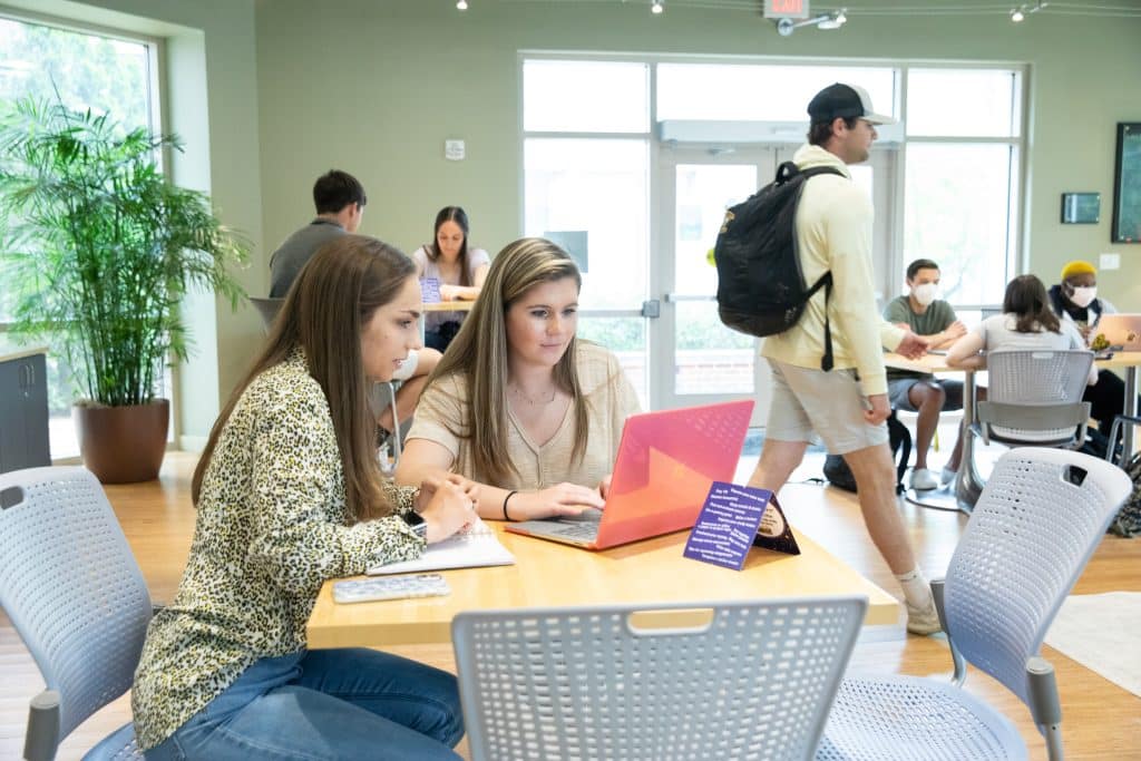 Two female Randolph-Macon students studying together at a table.