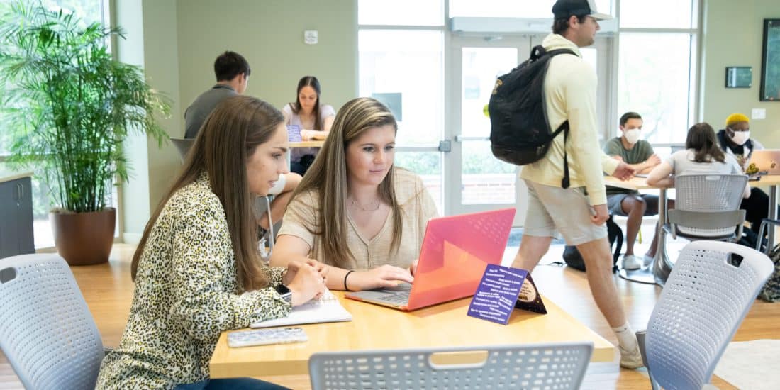 Two female Randolph-Macon students studying together at a table.