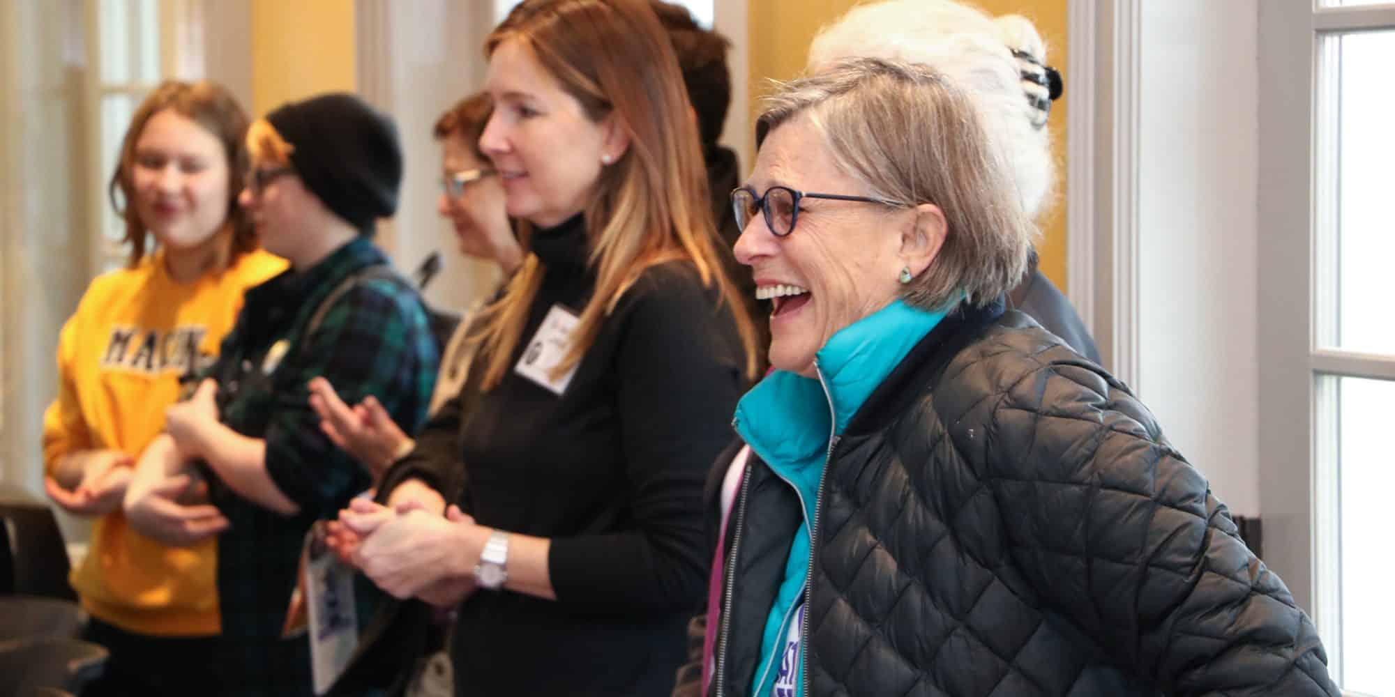 Group of students and faculty laughing together