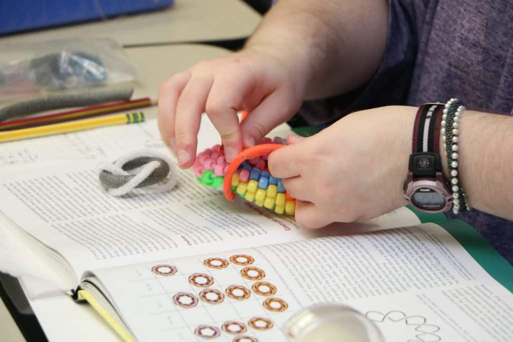 Student working on multi-sided bracelet