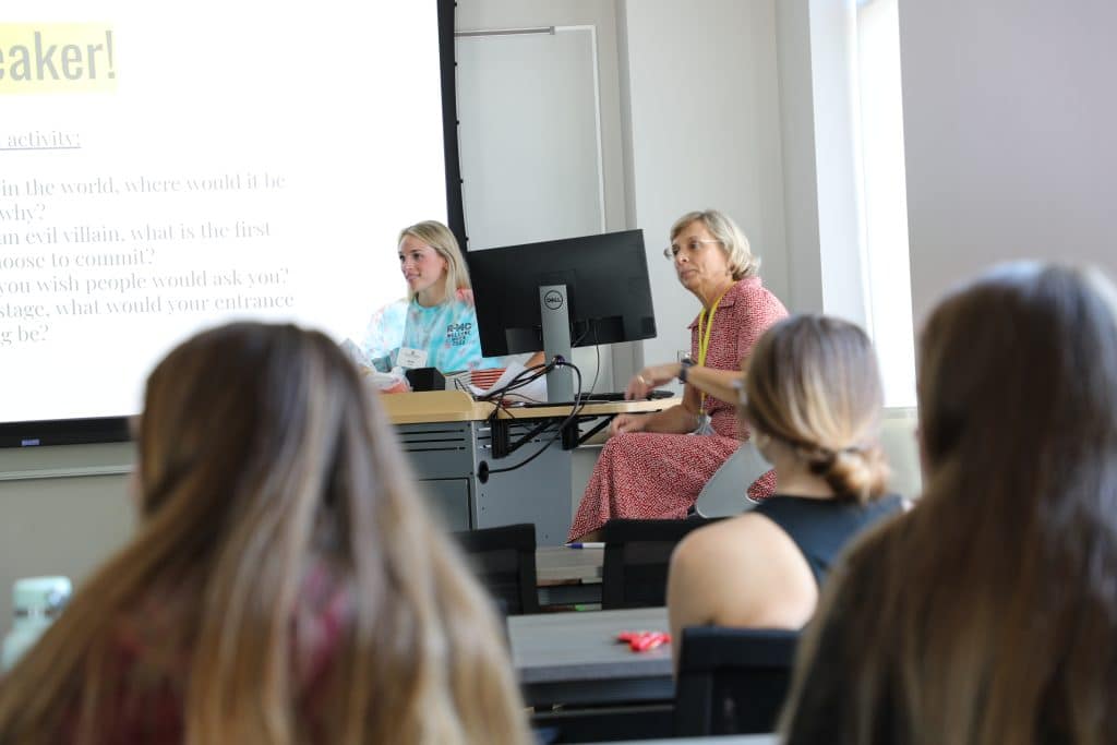professor and captain (student) at front of class