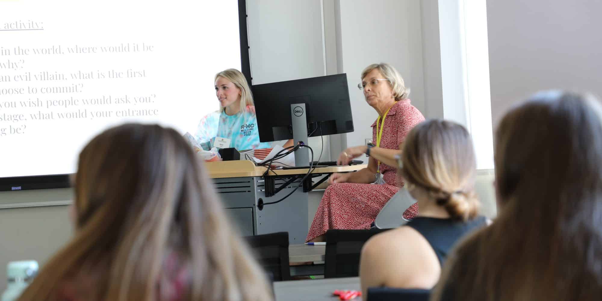professor and captain (student) at front of class