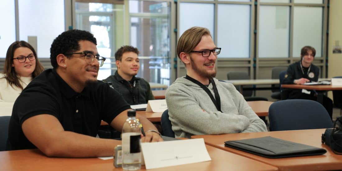Randolph-Macon Students smile while sitting in classroom during lecture