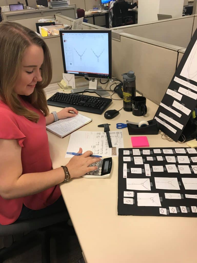 RMC economics major punching numbers into a calculator while sitting at a desk