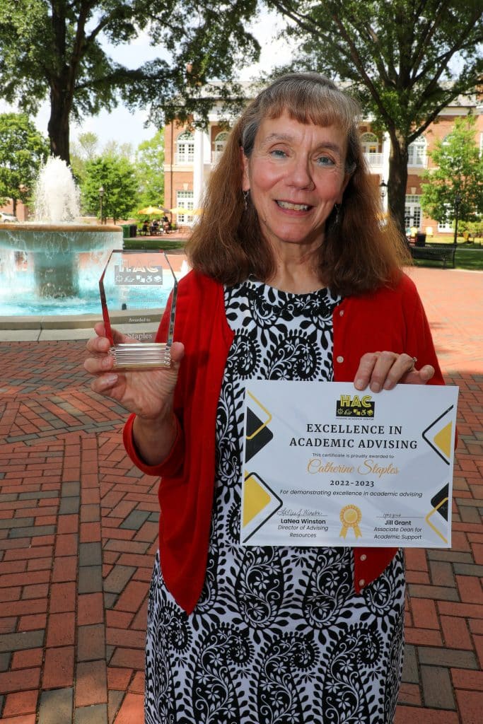 Cathy Staples poses with her Excellence in Academic Advising award