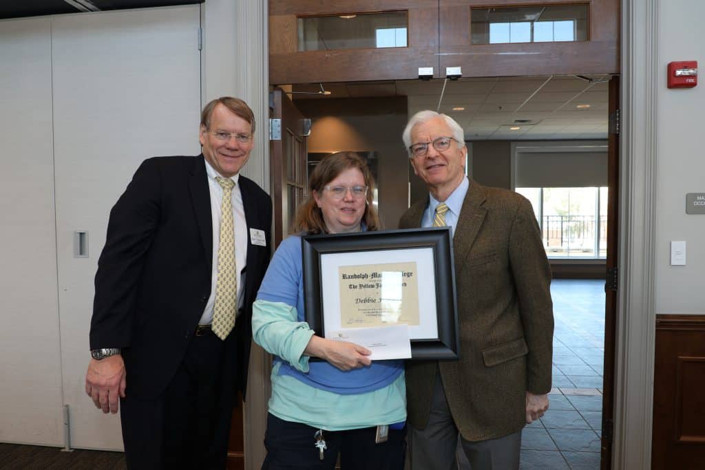 Debbie Harless with President Lindgren holding her Yellow Jacket Award