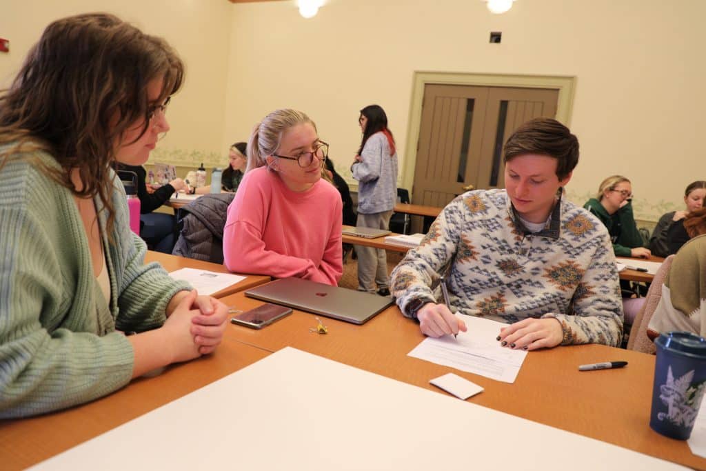 Students create a version of the board game Life during an activity in the Social Perspectives on Motherhood course