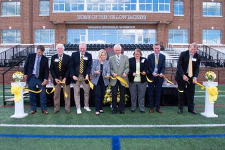Representatives from Randolph-Macon's administration and Board of Trustees cut the ribbon in front of Duke Hall