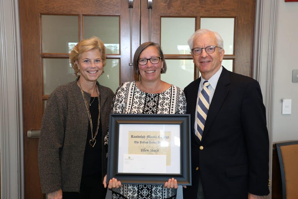 Josh Quinn poses with his Yellow Jacket Award certificate and President Lindgren