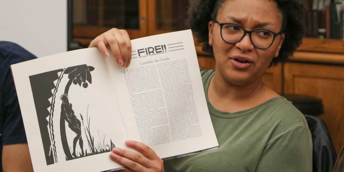 Randolph-Macon student holding a book in English class.