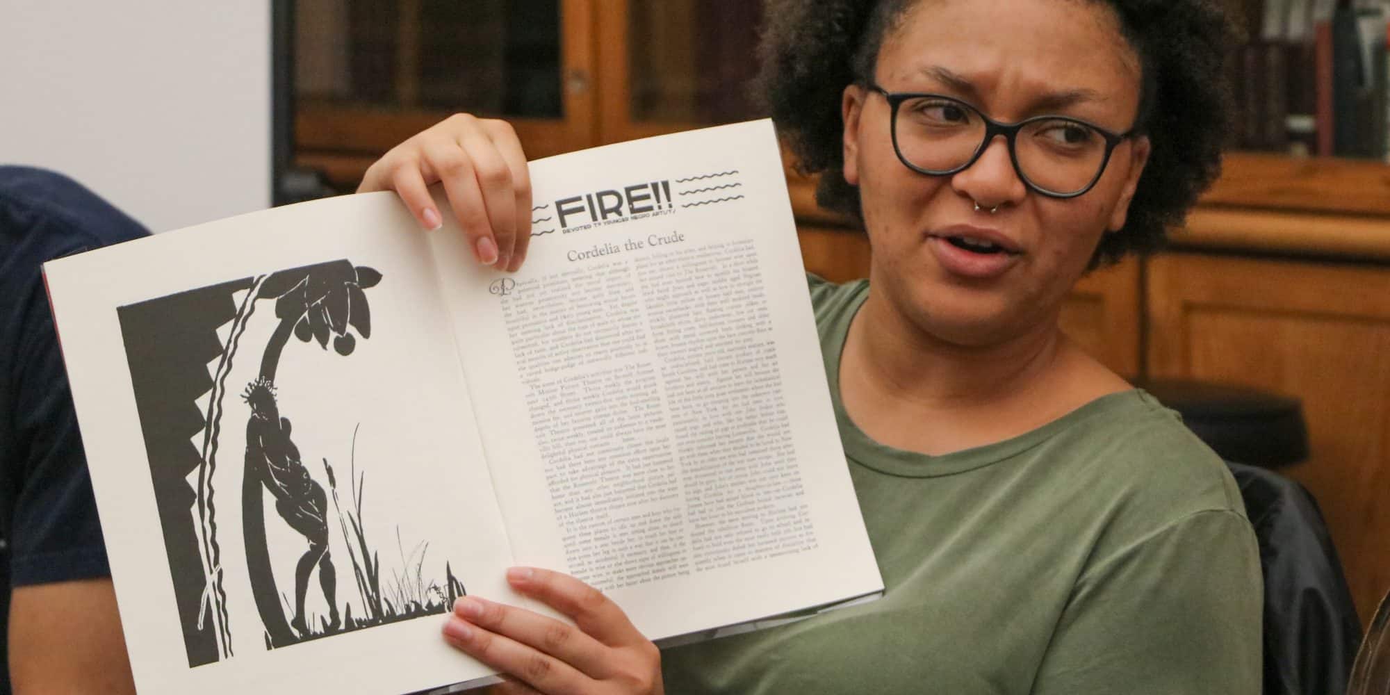 Randolph-Macon student holding a book in English class.