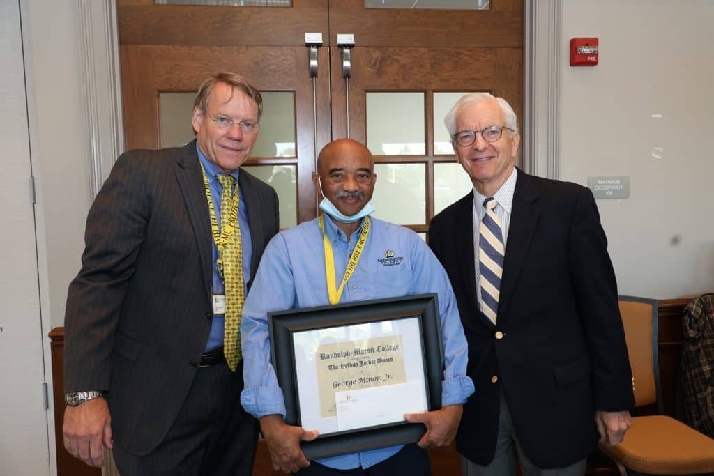 Josh Quinn poses with his Yellow Jacket Award certificate and President Lindgren