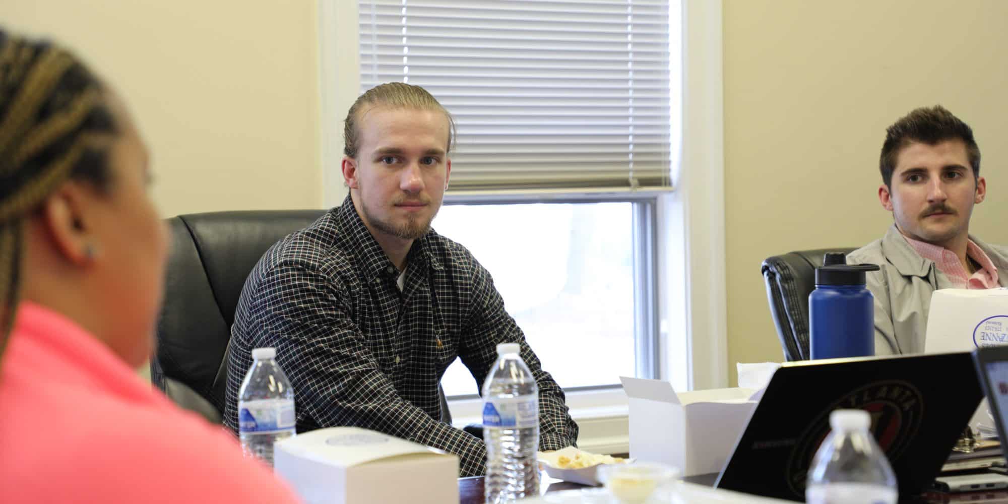 Randolph-Macon students interning while sitting at a table.