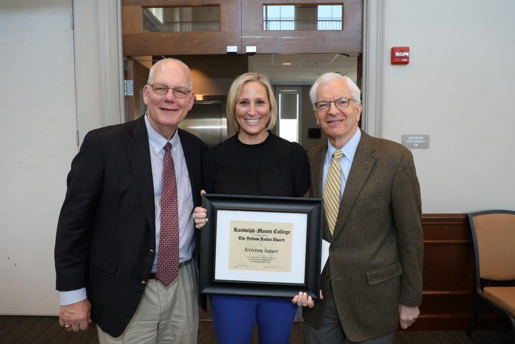 Kristen Sauer with President Lindgren holding her Yellow Jacket Award