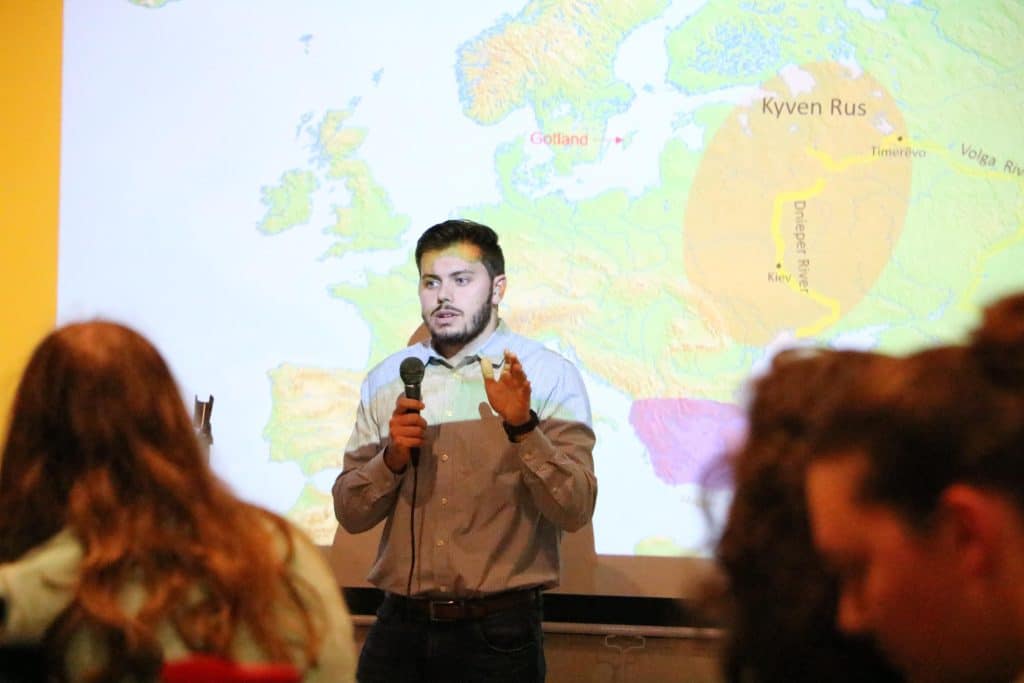 RMC senior Kyle Alberici speaks to an audience at Center of the Universe brewery.