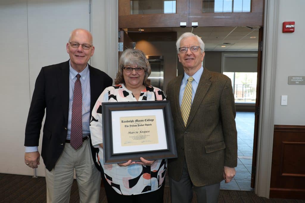 Marcie Krause with President Lindgren holding her Yellow Jacket Award