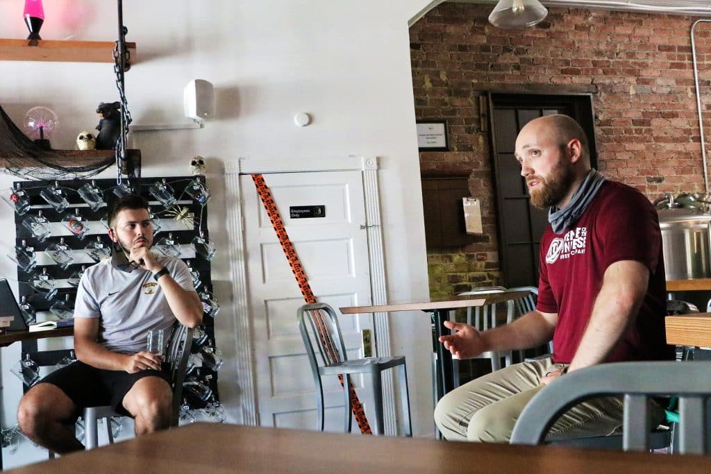 Center of the Universe head brewer Nathan Landers speaks to RMC students at Origin Beer Lab.