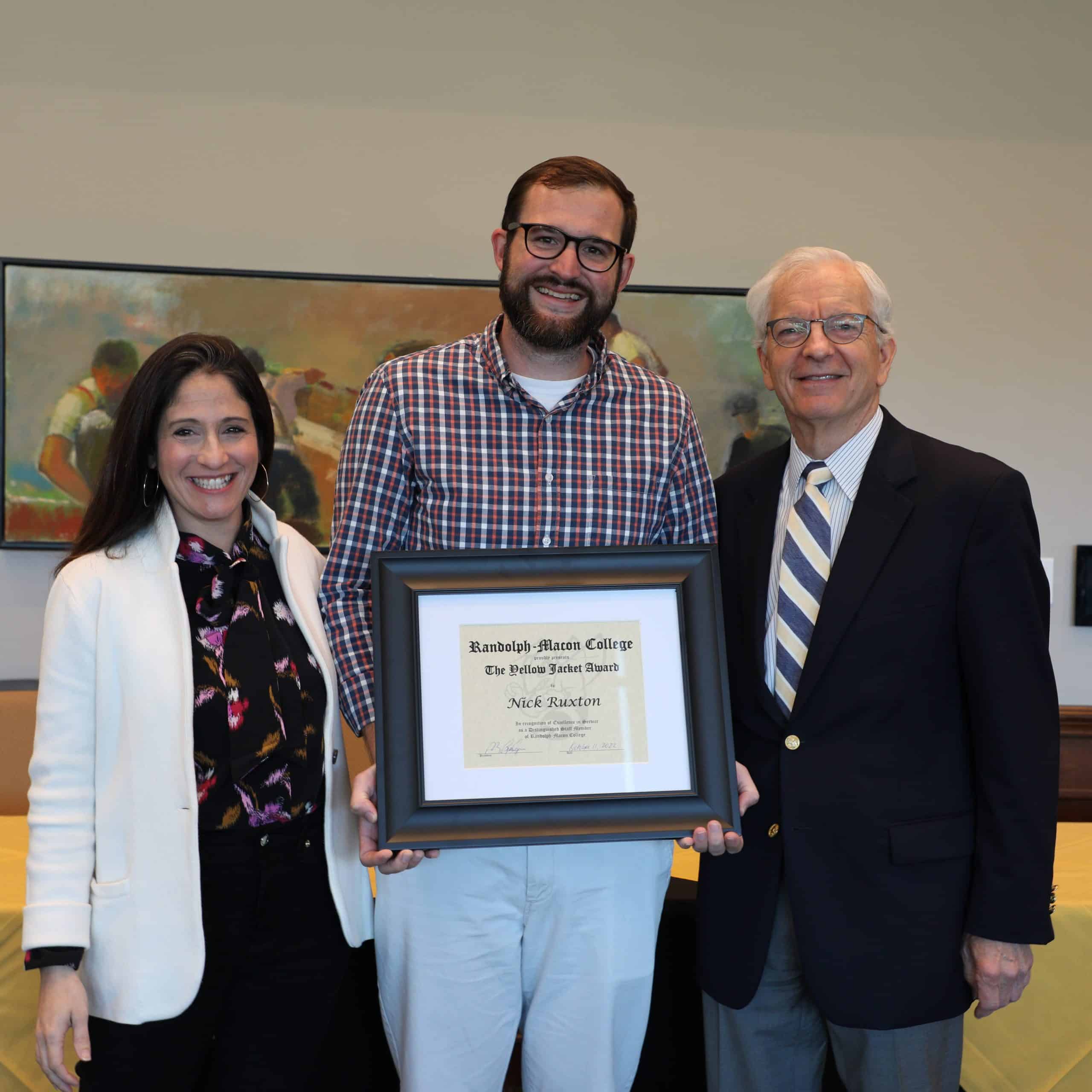 Nick Ruxton poses with his Yellow Jacket Award certificate and President Lindgren