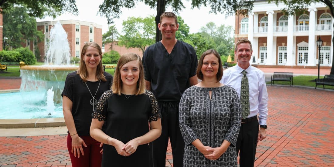 Members of the PA staff pose in front of the fountain.
