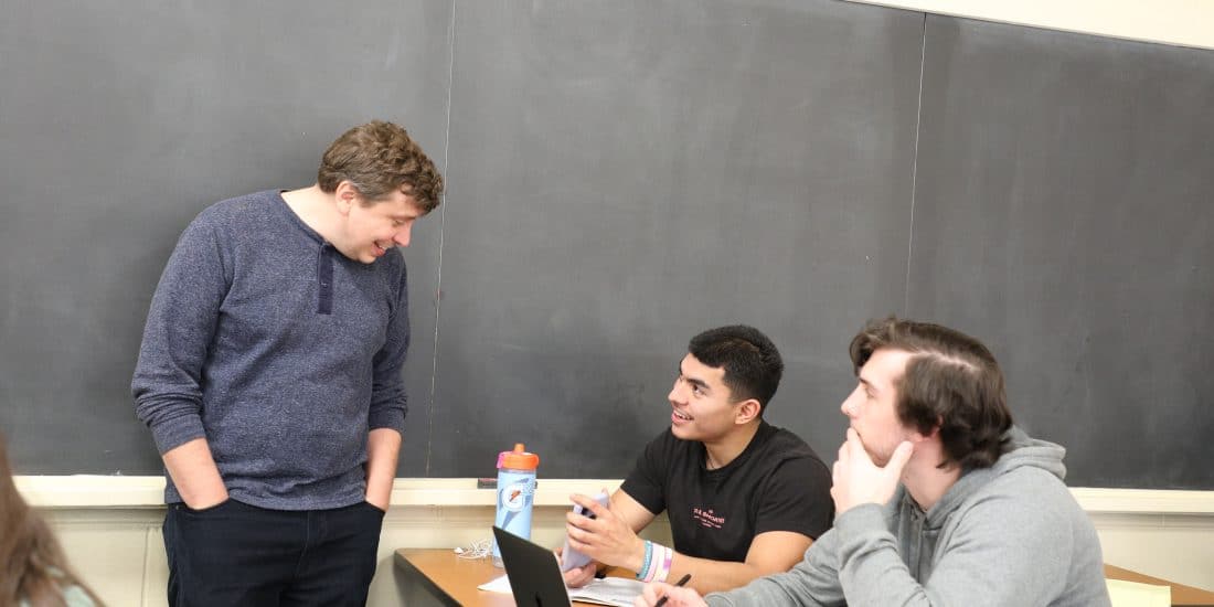 RMC communication studies students interacting with their professor