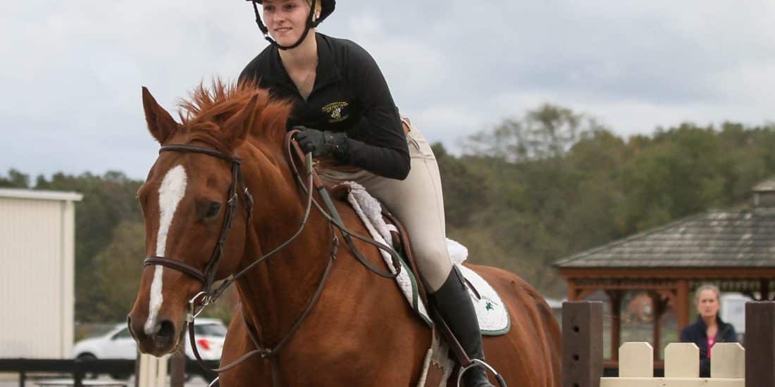 A member of the RMC equestrian team practices in the ring at the RMC Equestrian Center.