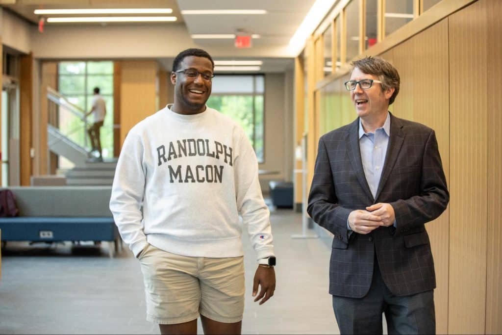 A student walking and talking with a professor
