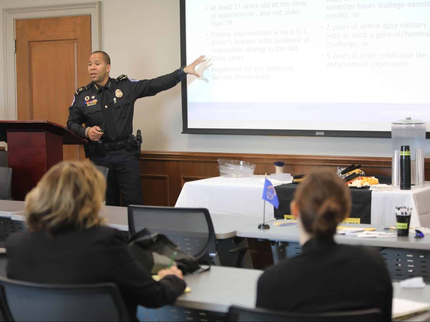 Law enforcement official making a presentation to criminology majors in class