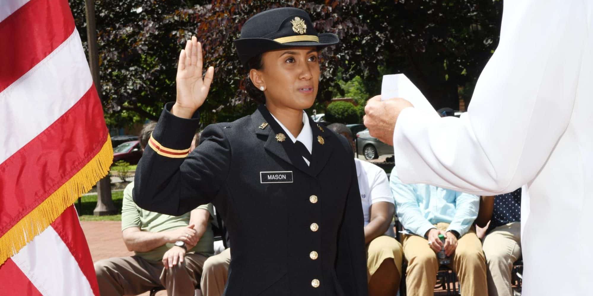 Randolph-Macon ROTC student stands with hand raised while taking an oath