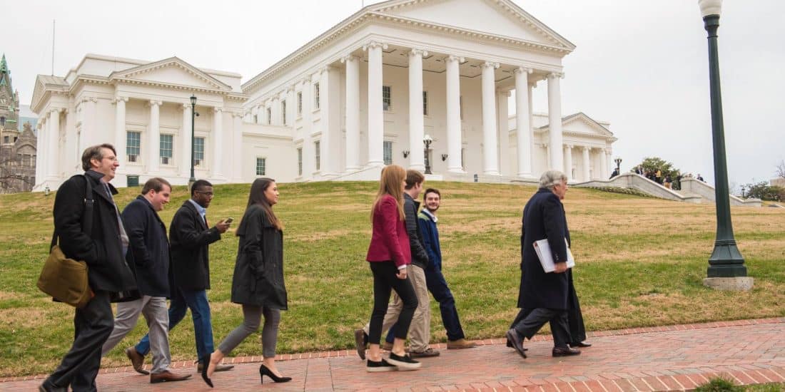Ranbdolph-Macon Political Science students walking with the Virginia state capitol in the background