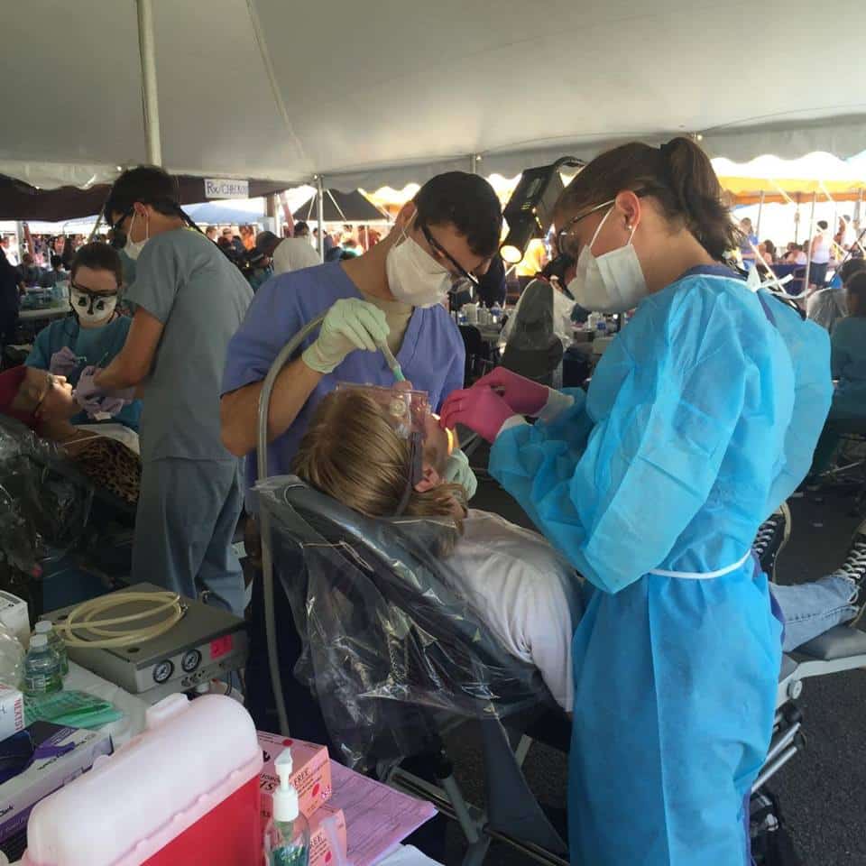 Pre-health students work with patients during clinic