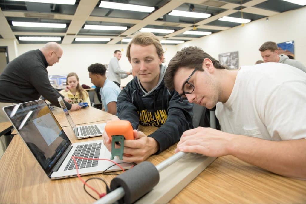 Two students working on engineering project in class