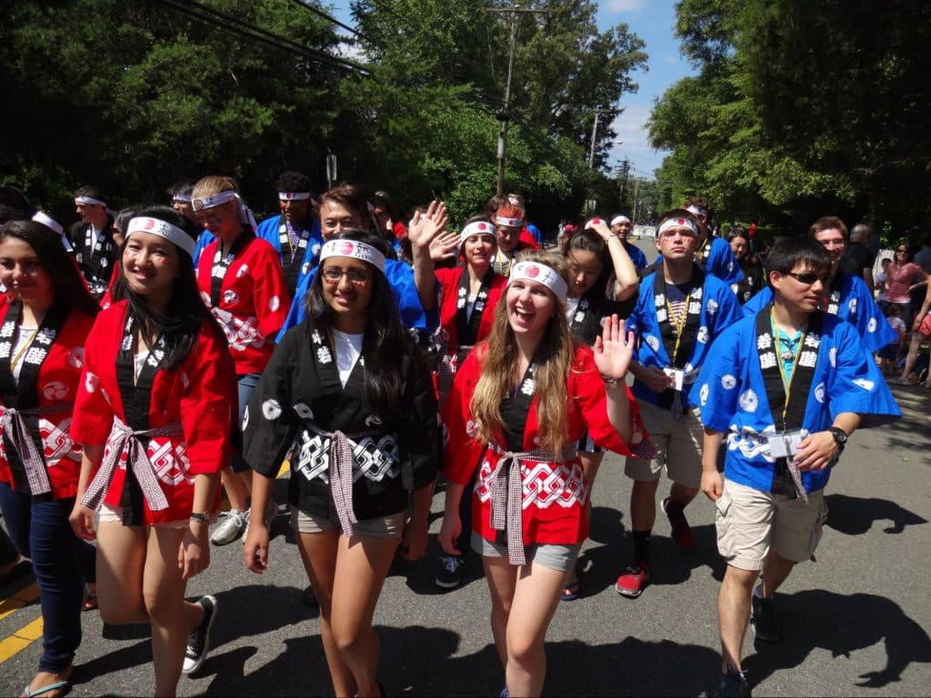 Japanese studies students marching in parade while wearing summer yukata