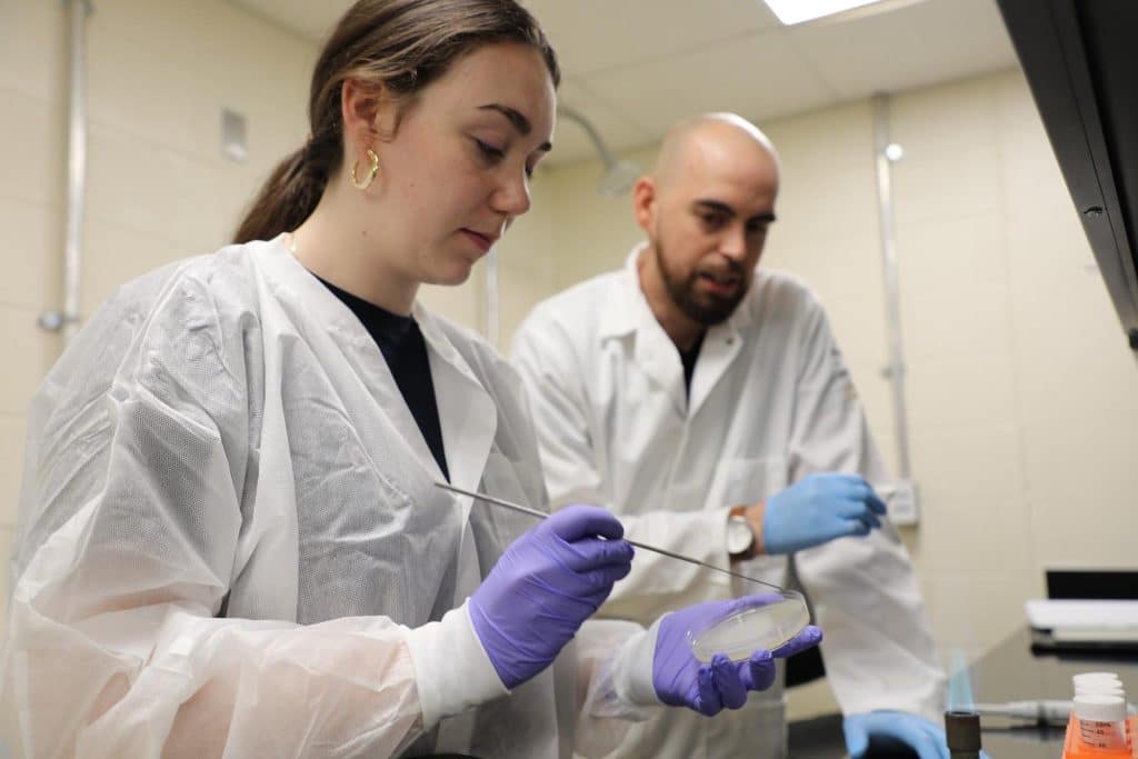 RMC biology students and faculty member conducting research in a lab