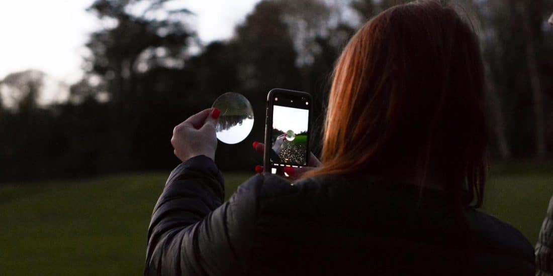 Student viewing the sunset via a mirror