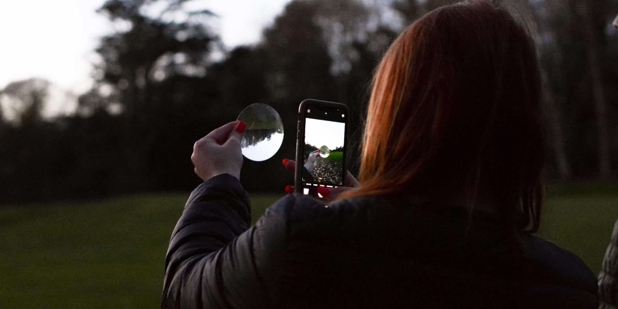 Student viewing the sunset via a mirror