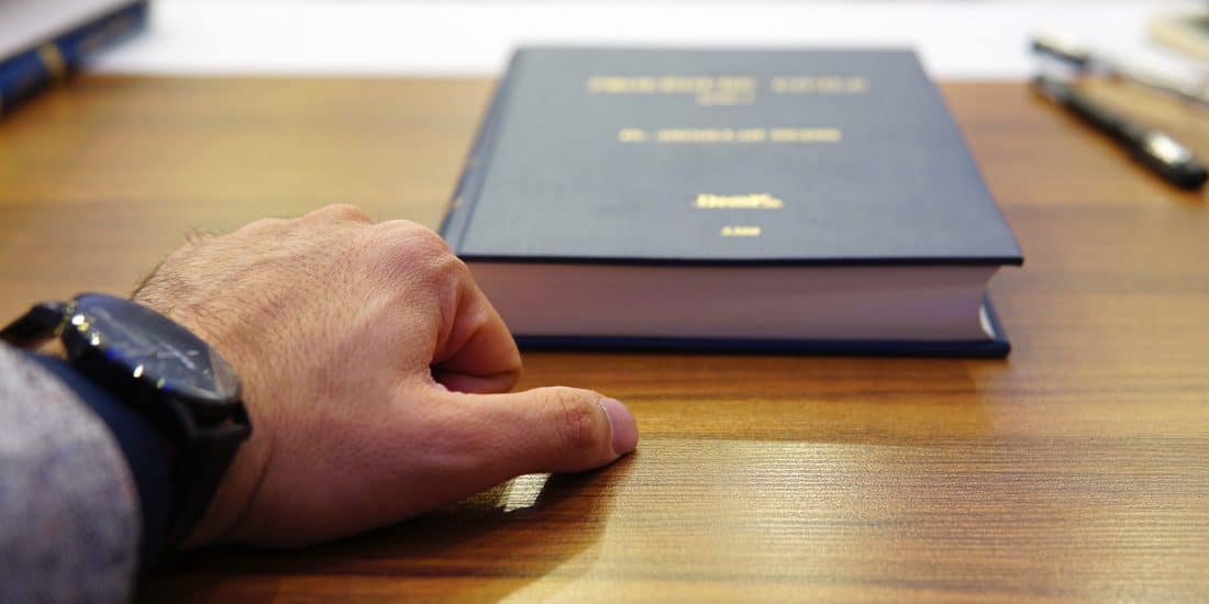 Close up of hand near a book