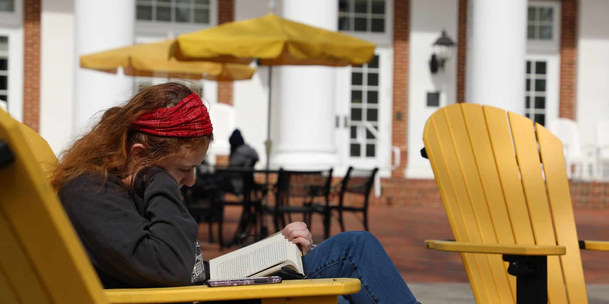 Randolph-Macon College student girl reading in Adirondack