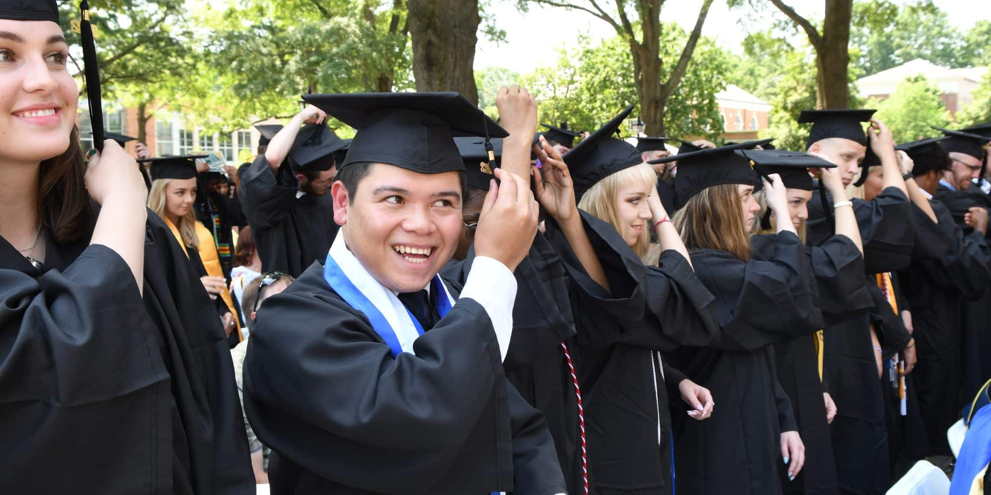 Randolph-Macon College class of 2022 turing their tassels during commencement.
