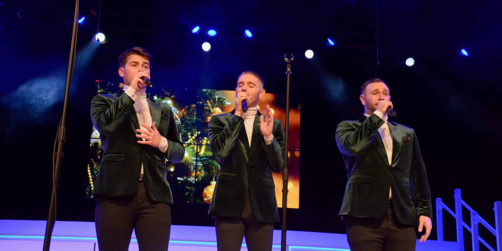 Three male Randolph-Macon college students singing during the Luxe show choir holiday spectacular