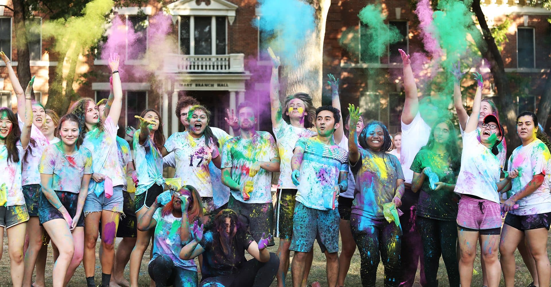 students with colorful chalk Holi