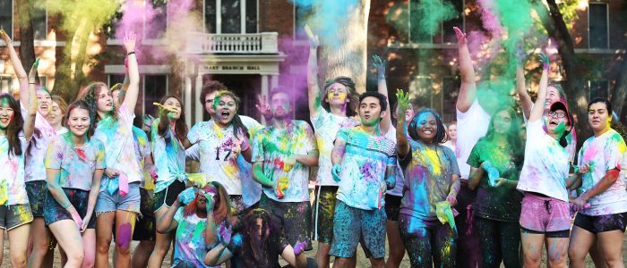 students with colorful chalk Holi