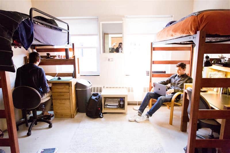 Two students working on class work in a dorm in Starr Hall