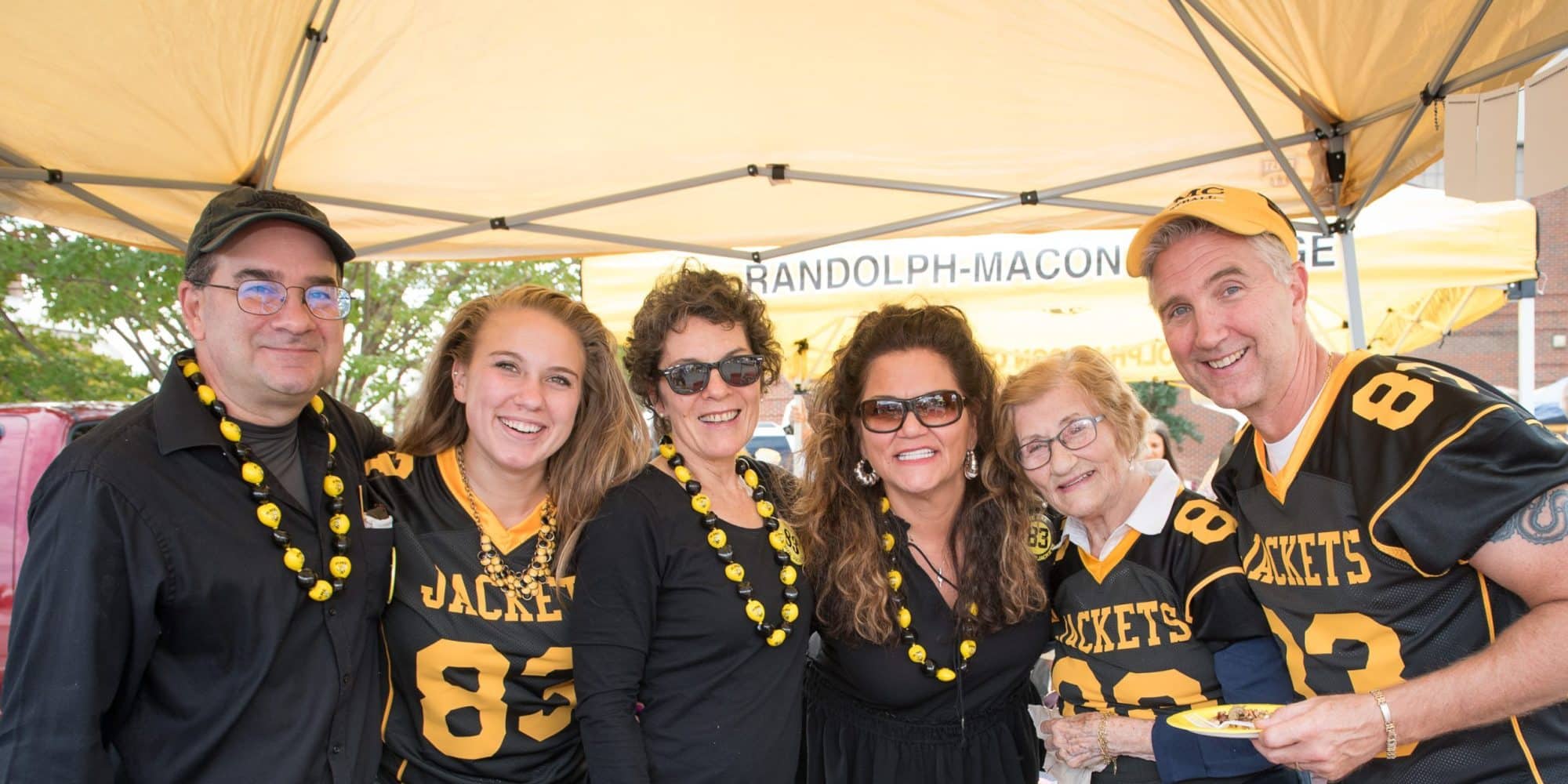 A group of RMC alumni pose for a photo during homecoming tailgate