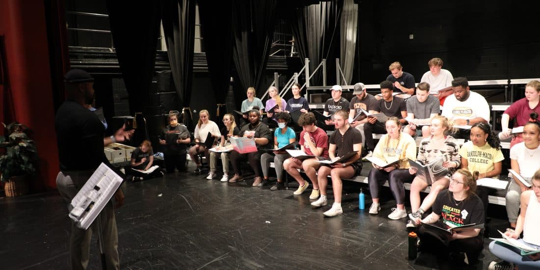 A group of people sitting on a stage.